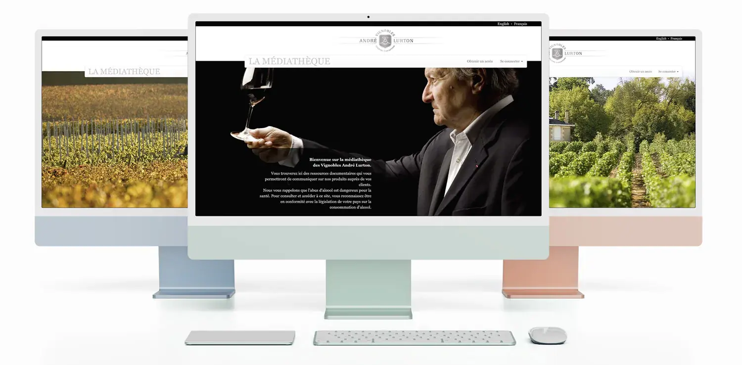 Three computers showing the André Lurton media library interface.
